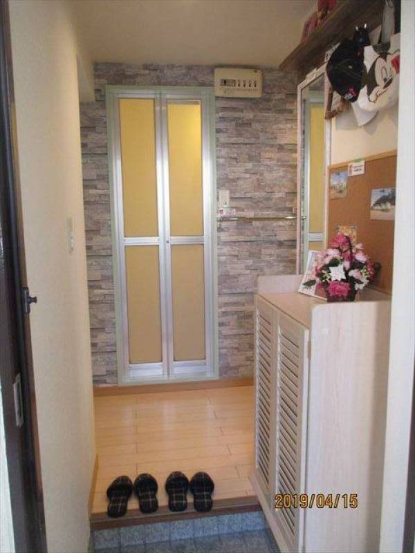 玄関ドアを開けると石張り調のアクセントクロスが印象的です。